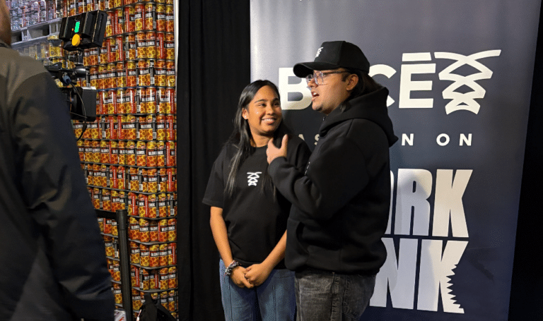 Founders Tanvi Gadamsetti adn Madhav Aggarwal speak to a media reporter at their watch party event.