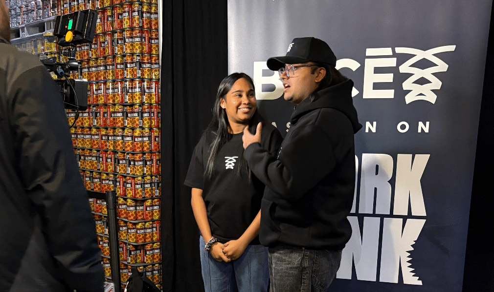 Founders Tanvi Gadamsetti adn Madhav Aggarwal speak to a media reporter at their watch party event.